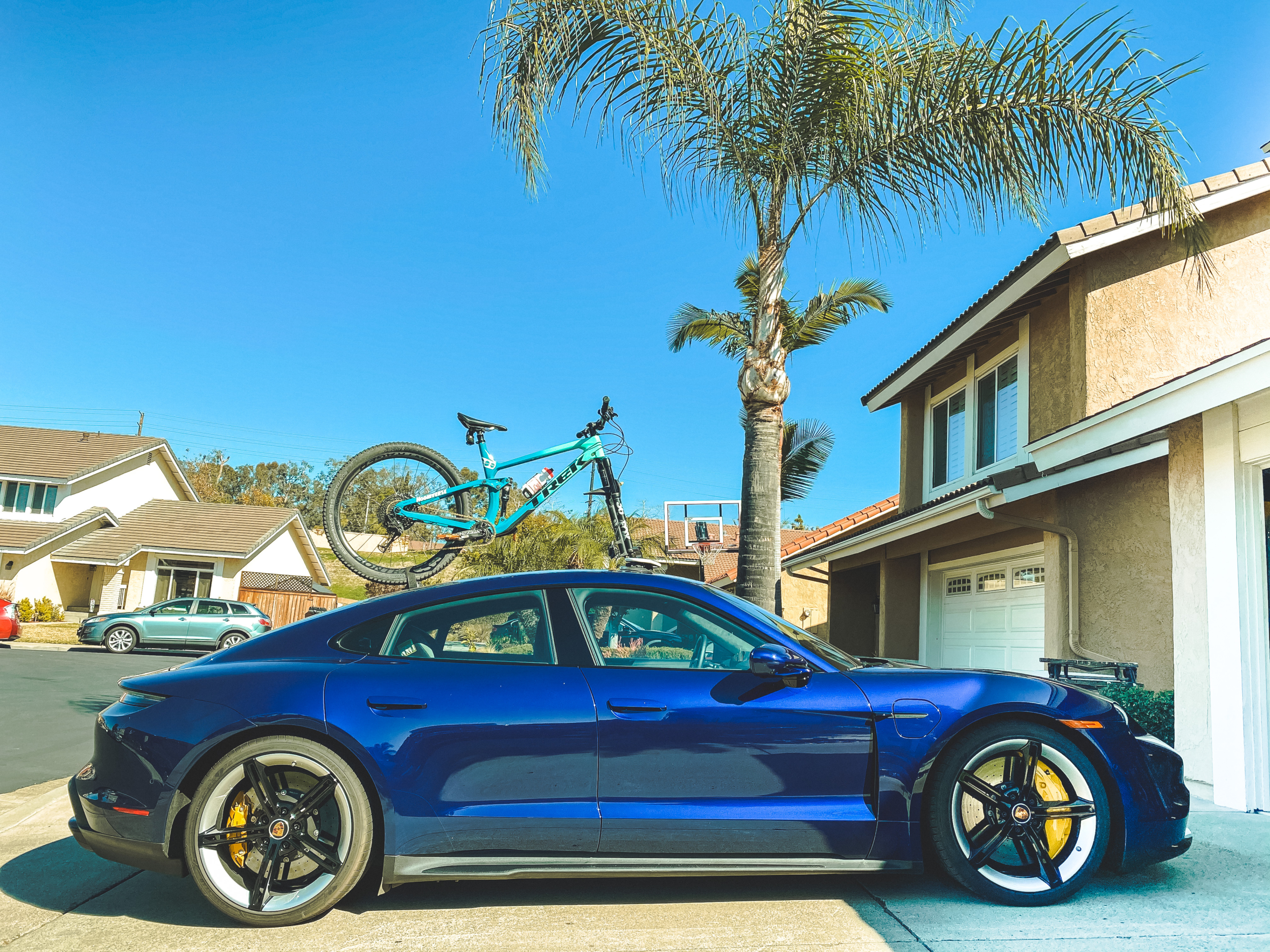 Porsche Taycan Turbo S with mountain bike on the roof